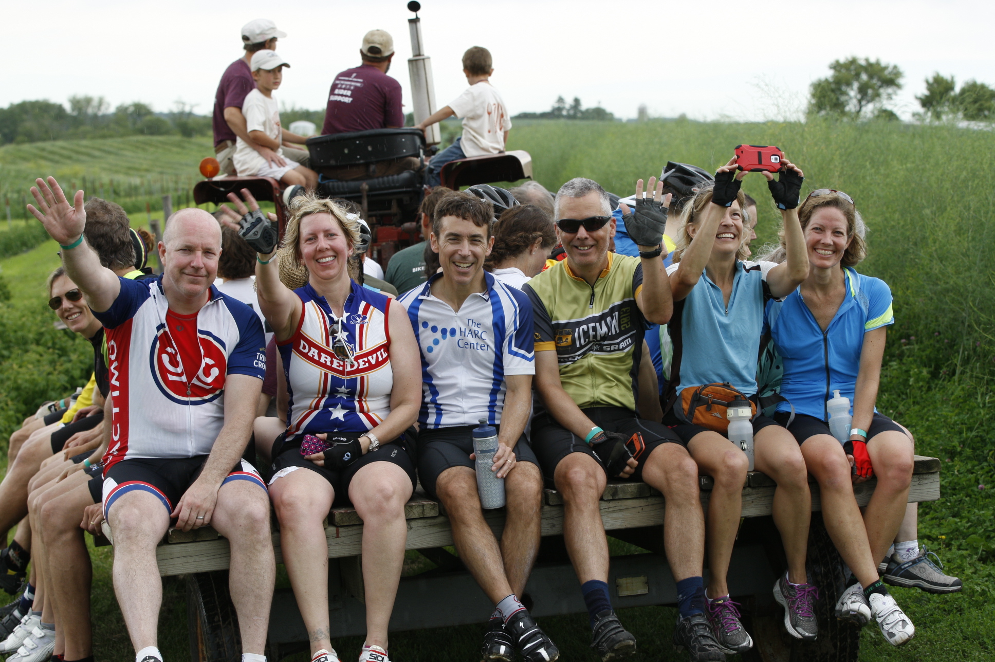 Bike the Barns participants enjoy a tractor ride at a farm stop.