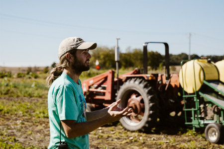 Farmer Mike Noltnerwyss of Crossroads Community Farm gives a tour of the farm. Photo by Light & Life Photography