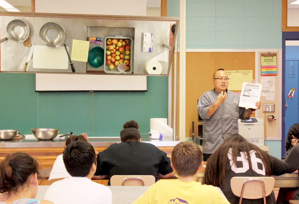Chef Tory Miller teaches students at Sherman Middle School how to make Flaming Hot Apples.