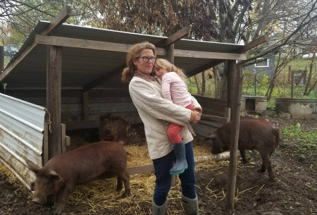 The author with her Red Wattle hogs and her granddaughter the day before the hogs go to market.
