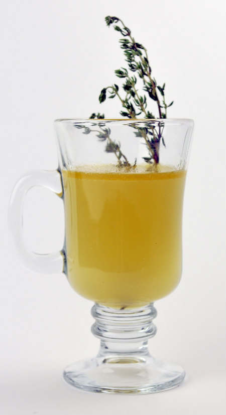 A mug of homemade chicken broth garnished with fresh thyme sprigs. Click for recipe. (Photo by Jim Klousia)