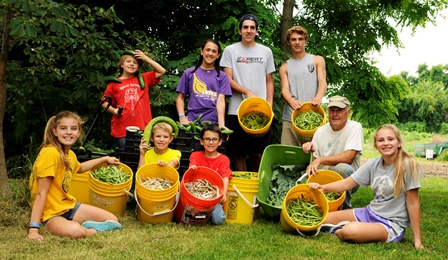 Local students visit the farm to learn from Tony (front row, second from right).