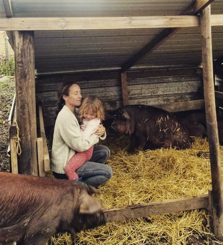 Jonnah Perkins, the author's daughter, saying goodbye to the family pigs.
