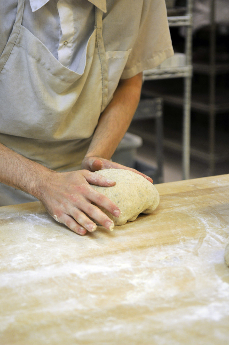 Hutchison kneading dough with a view of the floured countertop as well.