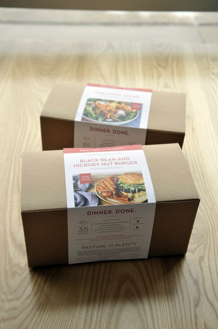 Two cardboard boxes holding Pasture and Plenty meal kit ingredients, labeled