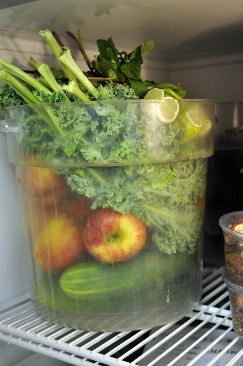 A bucket of various fresh fruits and vegetables that will go into Saints raw juices.
