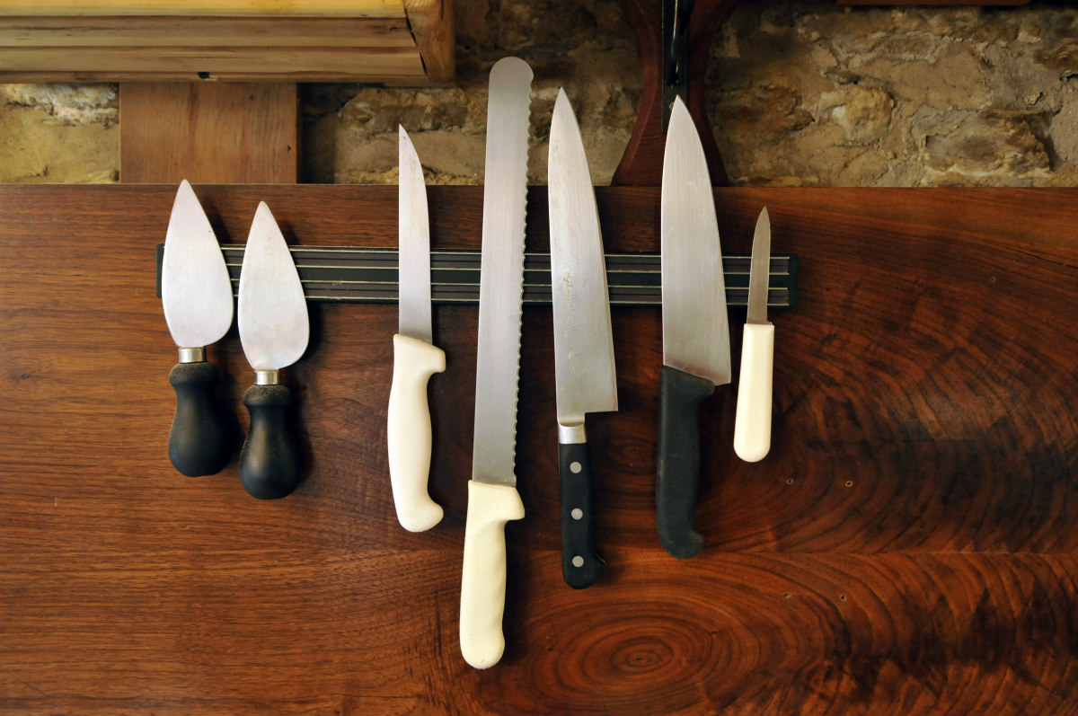 A row of knives on a magnetic strip on the wall at Underground Butcher.