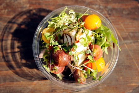 A PIG IN A FUR COAT: House made burrata with heirloom tomatoes, red onions, basil, balsamic and micro greens.