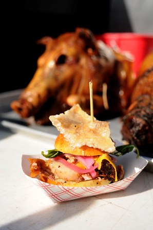 HERITAGE TAVERN - Roasted suckling pig porchetta, chile aioli, stone ground mustard, pickled red onion, fresh basil, soft bun and chicharon